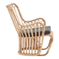 Natural bamboo rocking chair with a sleek, open pattern and a dark gray cushion, perfect for stylish decor.