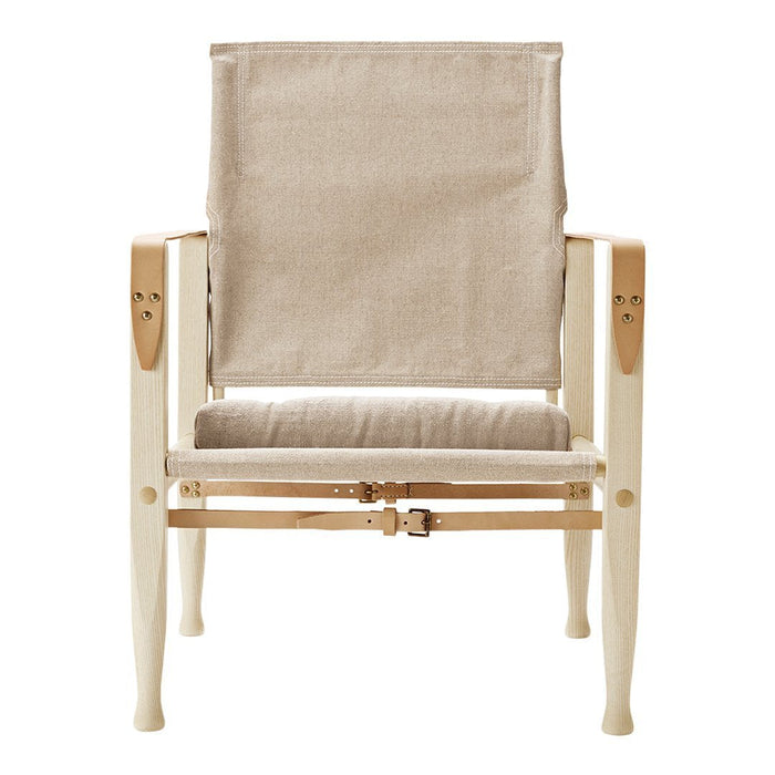Light beige fabric with a simple, woven texture on a minimalist wooden chair frame in pale natural tones.