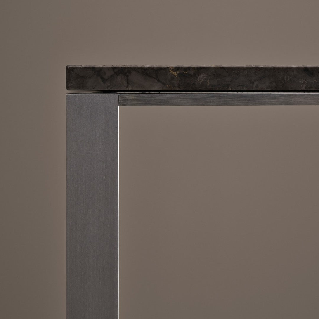 Gray metal frame with a rugged dark stone top against a neutral background. Perfect for modern decor.