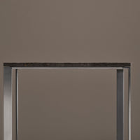 Black marble tabletop with a sleek silver frame, set against a neutral brown background. Elegant and modern design.