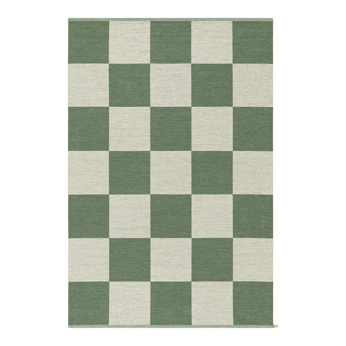 Green and cream checkerboard rug with a bold, geometric pattern. Ideal for modern decor.