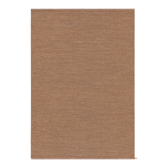 "Textured brown area rug featuring a subtle woven pattern, perfect for adding warmth to any space."