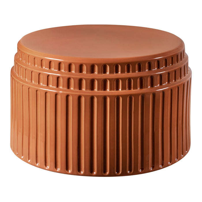 Terra-cotta round ottoman with vertical ribbed texture, adding warmth and style to any space.
