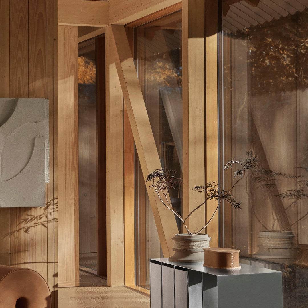 "Warm wood tones and soft neutral hues create a serene, modern interior with minimalist patterns."