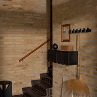Stylish brown brick wall with smooth black accents and warm wooden tones, featuring geometric patterns and textures.