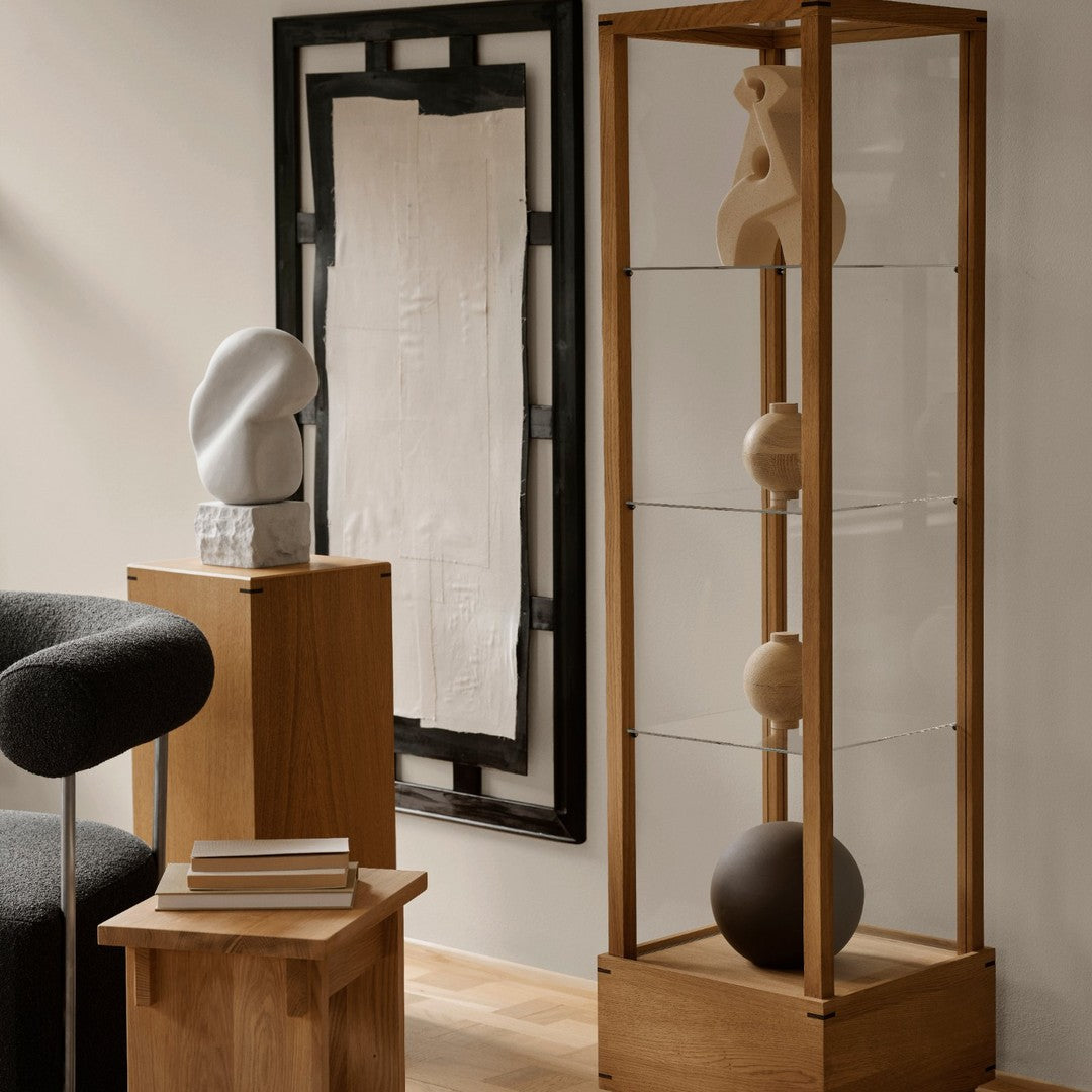 Modern display case featuring wood and glass with neutral color tones and smooth, minimalist shapes.