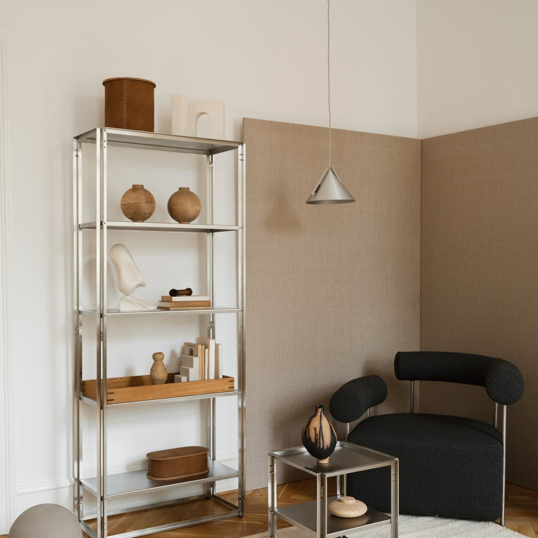 Modern shelving unit with a silver finish, styled with neutral tones and natural textures, ideal for contemporary decor.