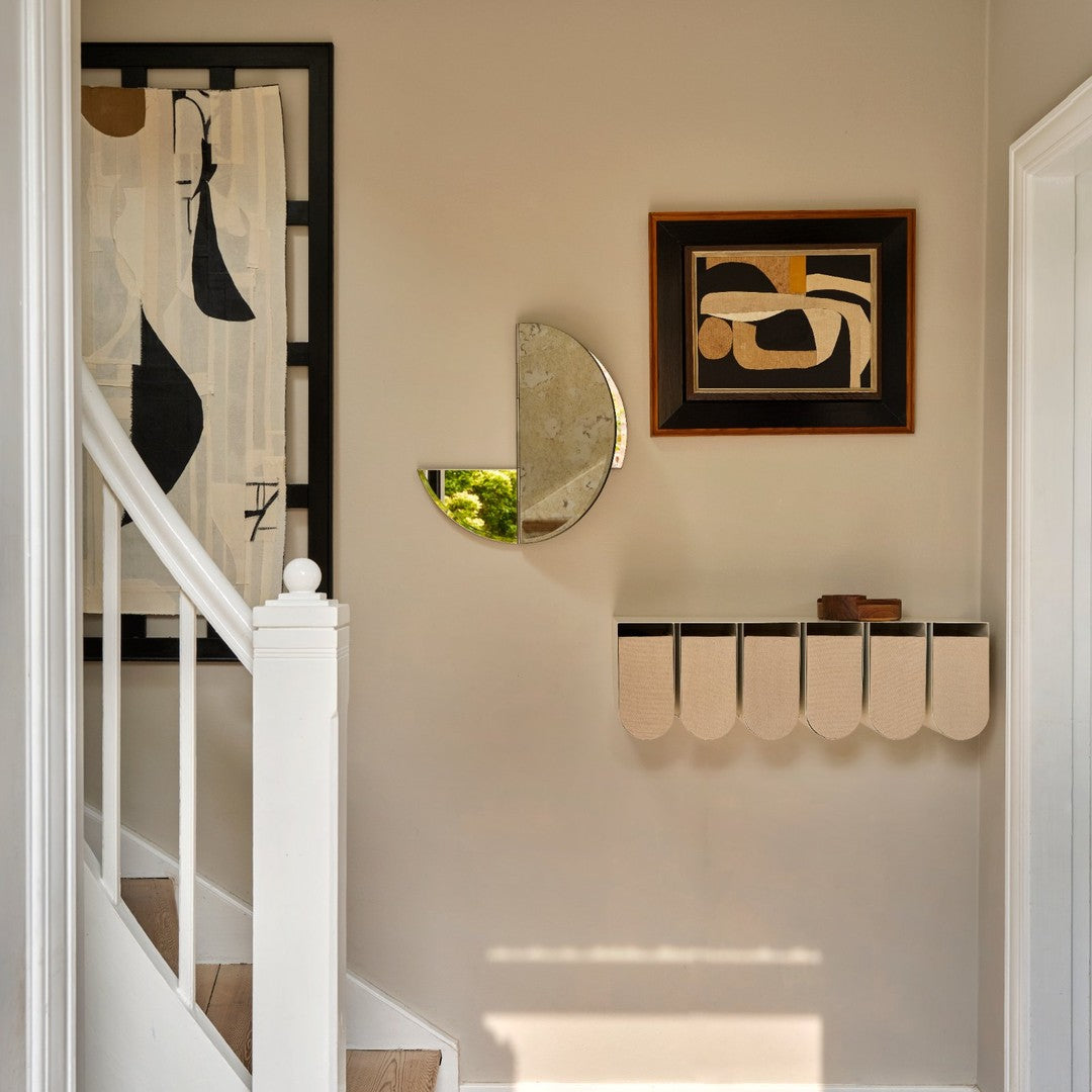 Neutral walls with abstract black and cream patterns, featuring circular and geometric shapes in art and decor elements.