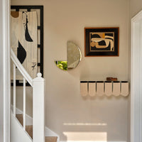 Neutral walls with abstract black and cream patterns, featuring circular and geometric shapes in art and decor elements.