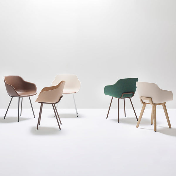 Five modern chairs in beige, brown, green, and cream, showcasing sleek lines and minimalist design.