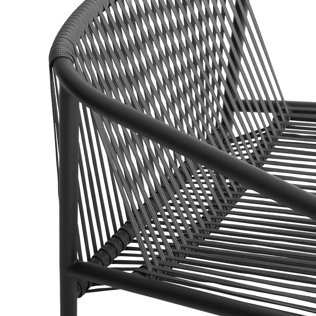 Black woven metal bench with sleek lines and unique tubular pattern, perfect for modern outdoor spaces.
