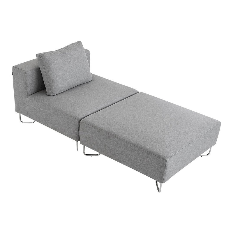 Light gray chaise lounge with a sleek, minimalist design and textured upholstery. Stylish metal legs complete the look.