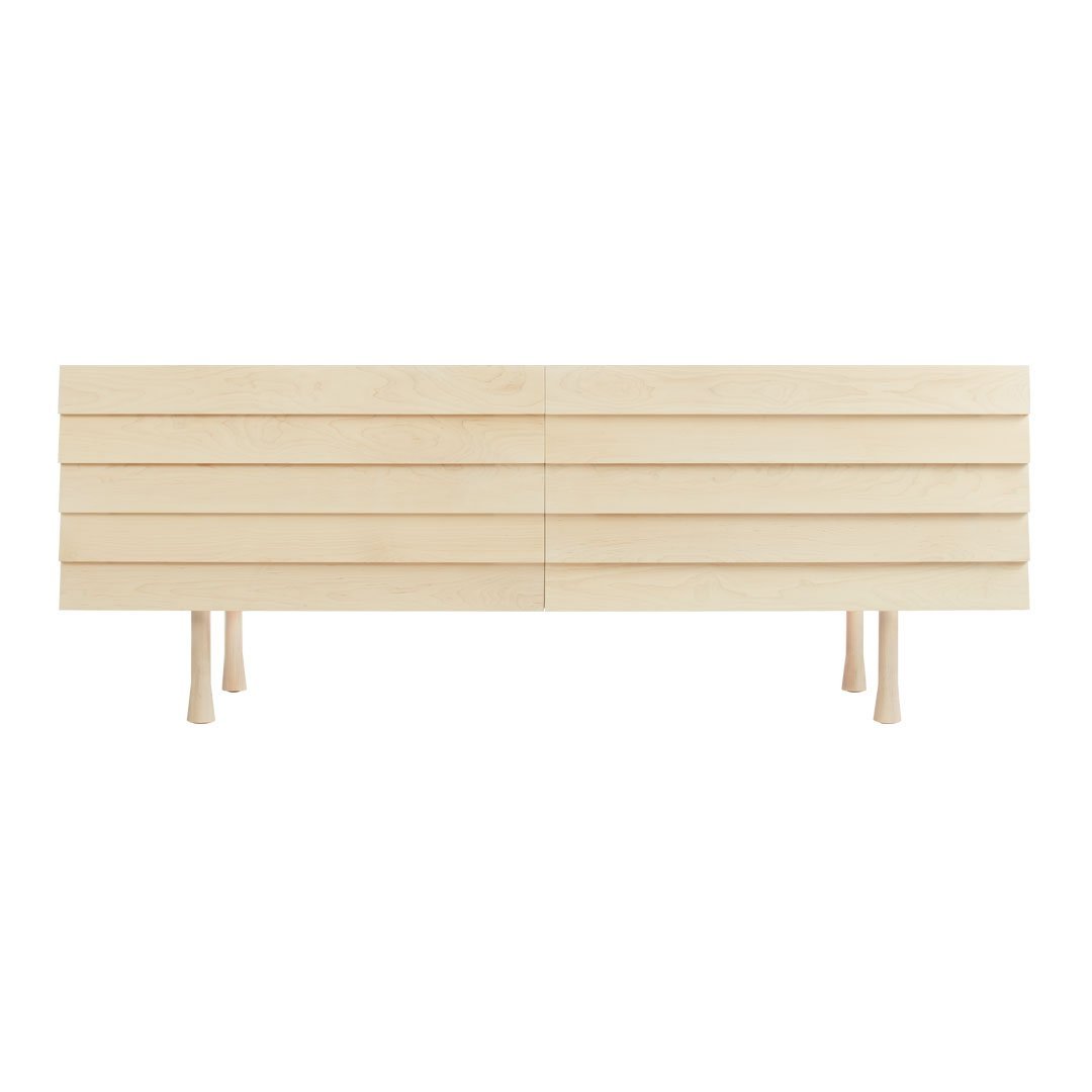 Light natural wood TV stand with slatted design and minimalistic legs, showcasing a clean and modern aesthetic.