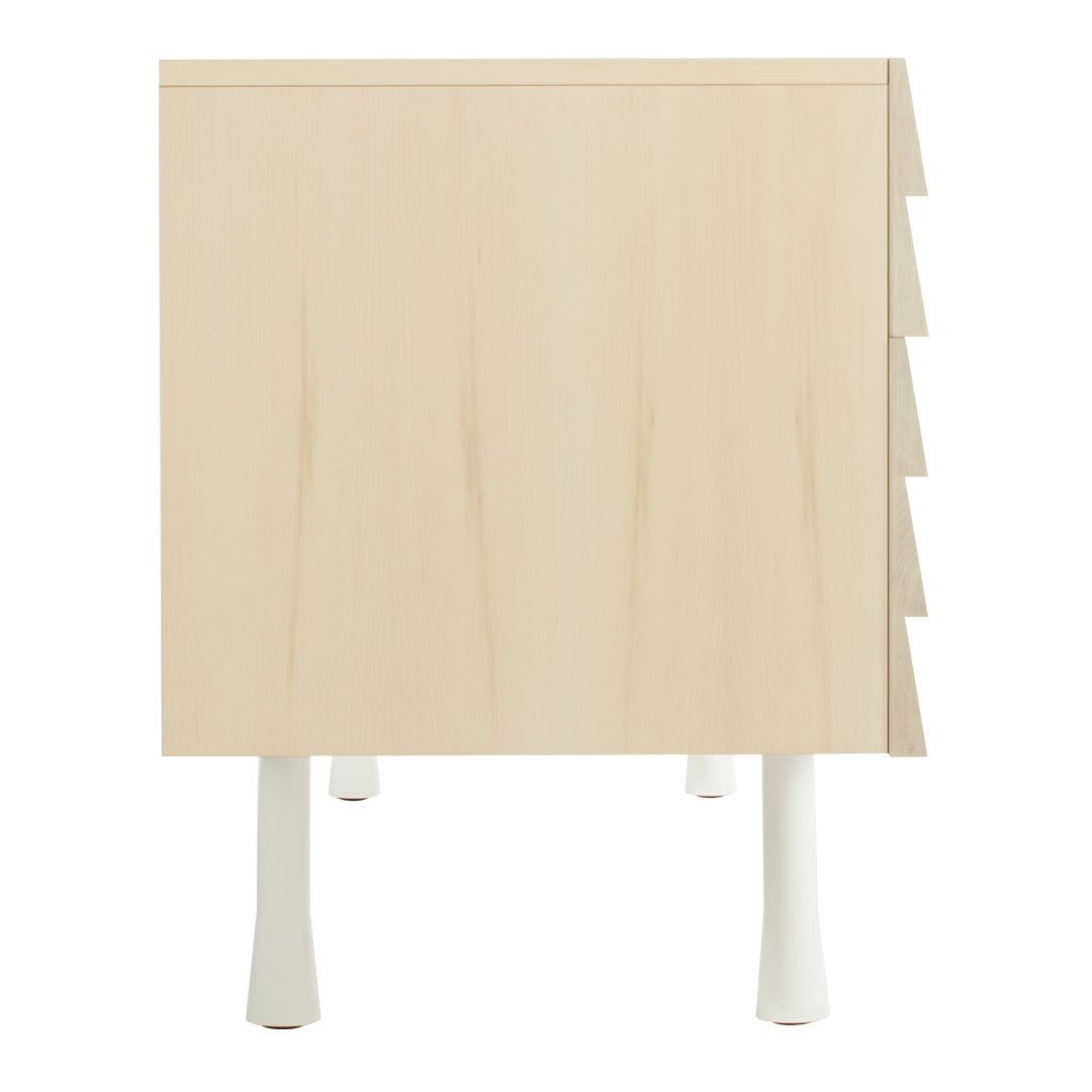Light wood nightstand with a smooth finish and white legs, featuring a minimalist, modern design.