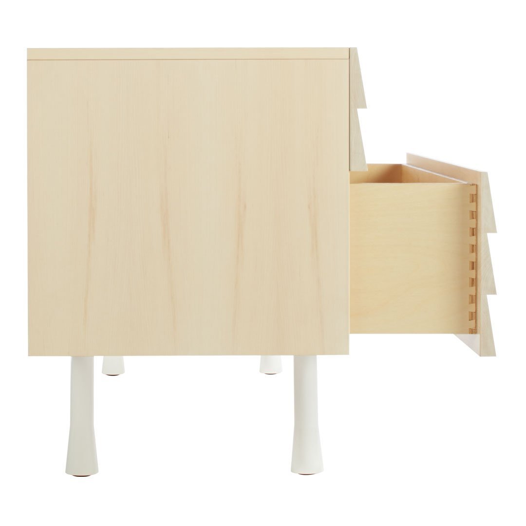 Light maple wood nightstand with white legs and a clean, minimalist design featuring a simple drawer pattern.