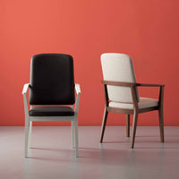 "Two stylish chairs: one in black leather with a white frame, the other in light beige fabric with a wooden frame."