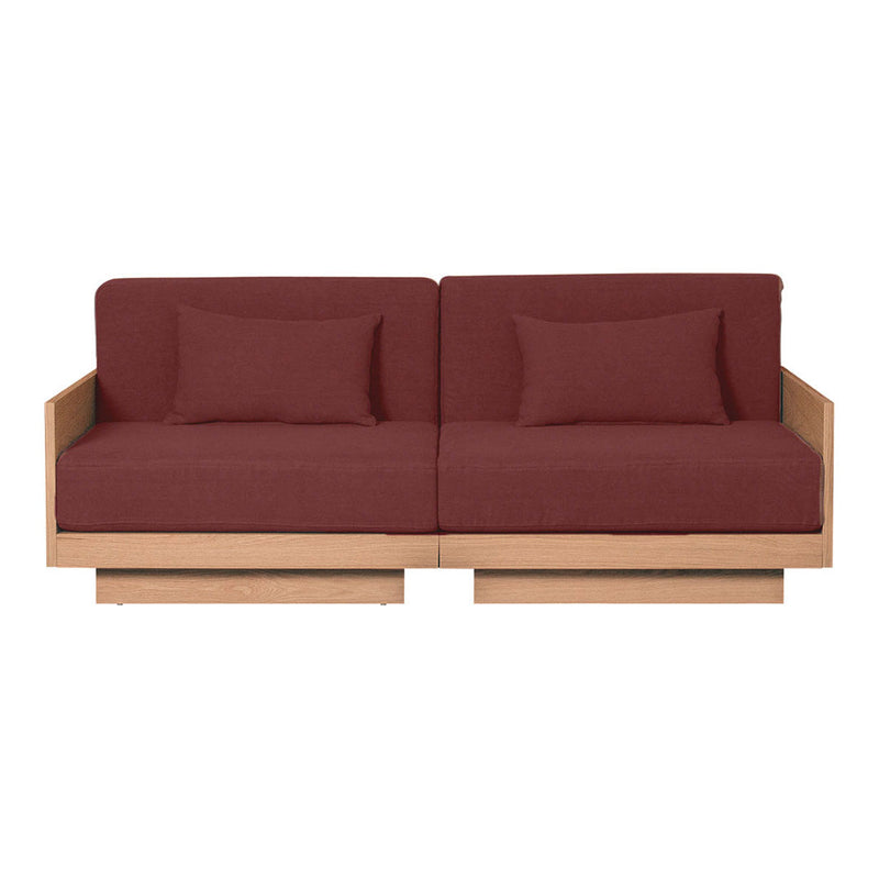 Modern two-seater sofa in rich burgundy fabric with simple, clean lines and natural wood accents.