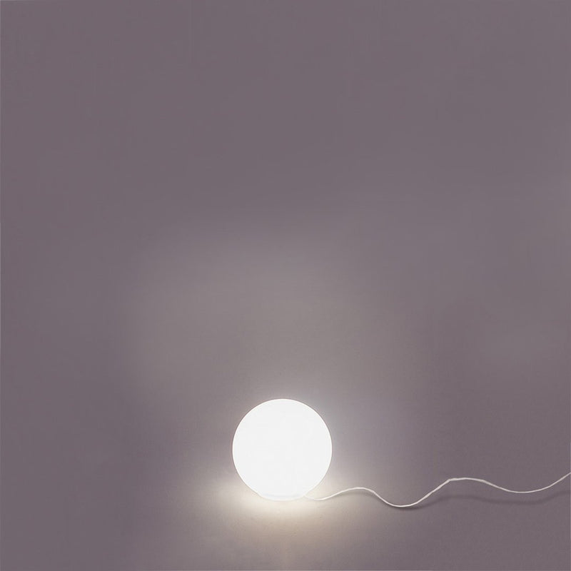 Round white lamp on a soft gray background, illuminated with a smooth, minimalistic design.