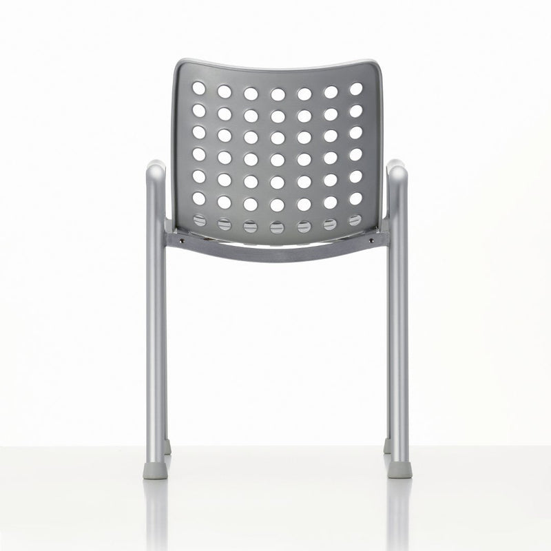 Gray chair with a perforated backrest and silver metal legs against a white background.