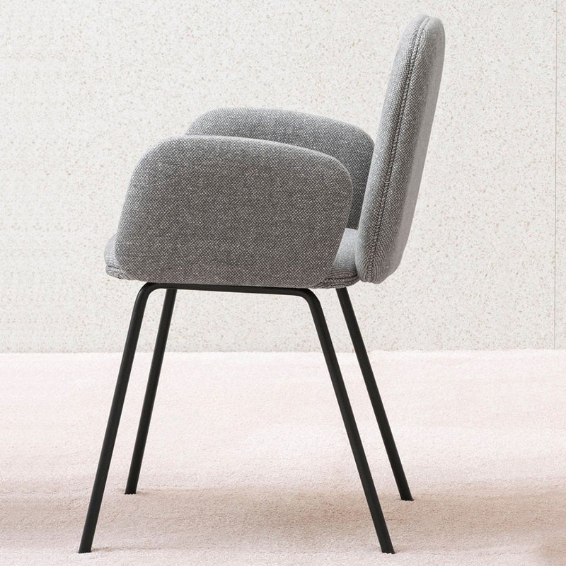 Gray upholstered chair with rounded backrest and sleek black metal legs, featuring a simple, modern design.