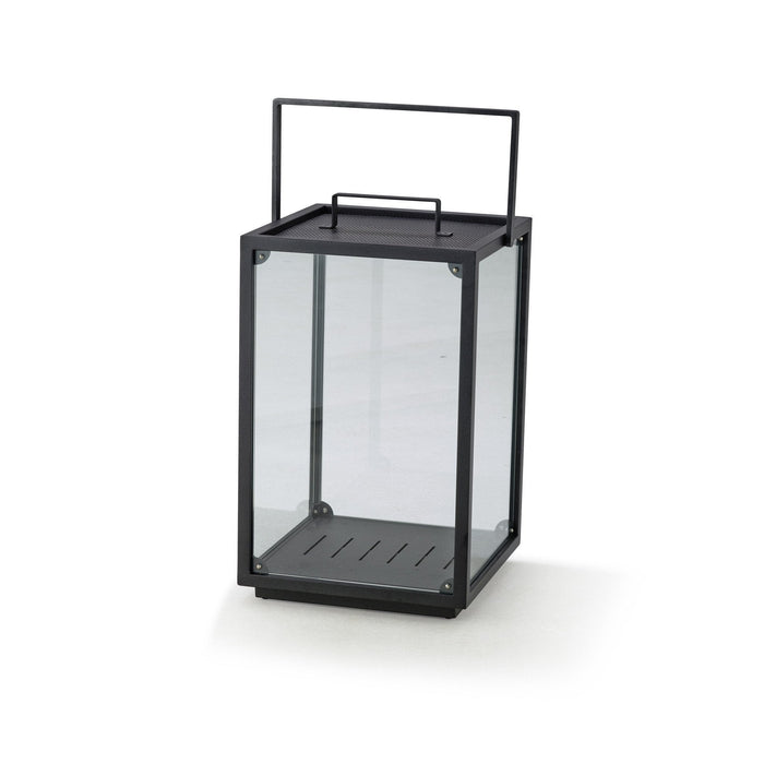 Black metal lantern with clear glass panels and linear interior slats, perfect for modern décor.