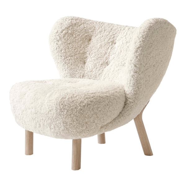 Cozy white faux shearling chair with a curved design and natural wood legs, perfect for modern decor.
