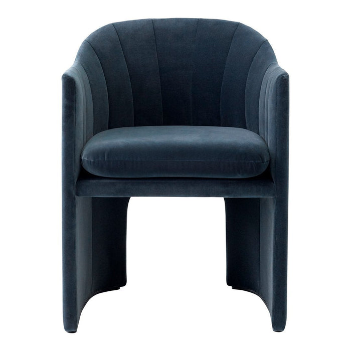 Velvet armchair in deep navy blue with elegant curved lines and a smooth, plush texture.