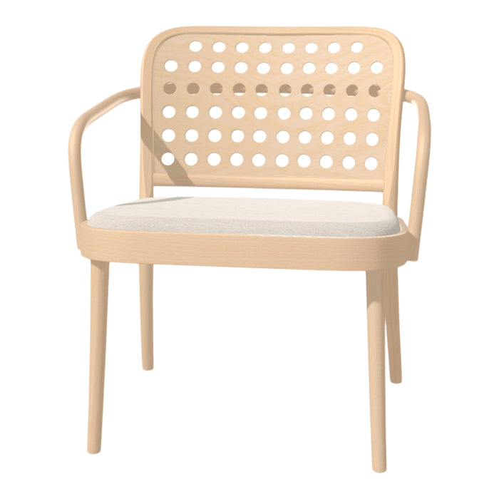 Beige chair with cut-out dot pattern and a white cushion, perfect for modern decor.