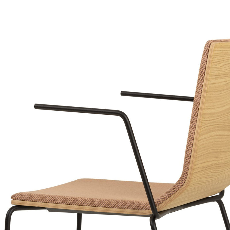 Light wood and tan fabric chair with minimalist black metal frame, featuring subtle geometric patterns.