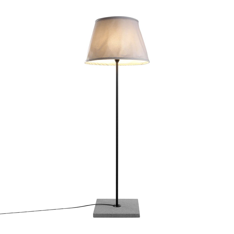 Modern floor lamp with a sleek black base and a soft beige, fabric shade, perfect for contemporary decor.