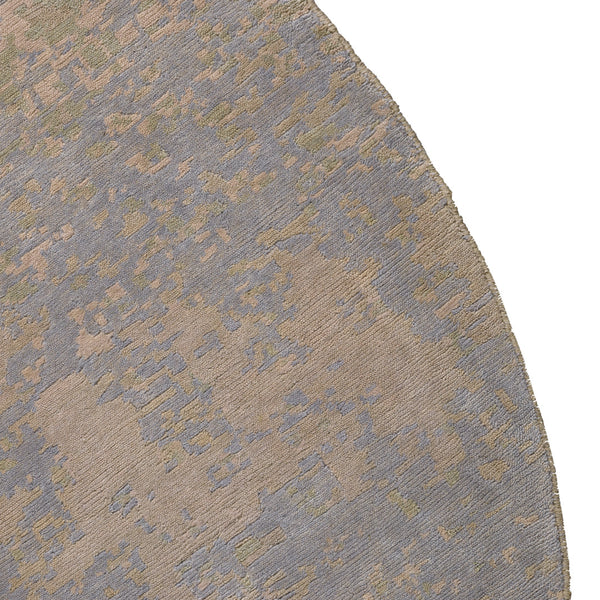 Circular rug featuring a textured pattern in soft blue and warm beige tones.