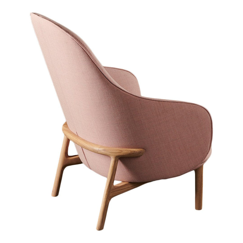 "Curved pink fabric chair with light wood legs and a smooth, minimalist design."