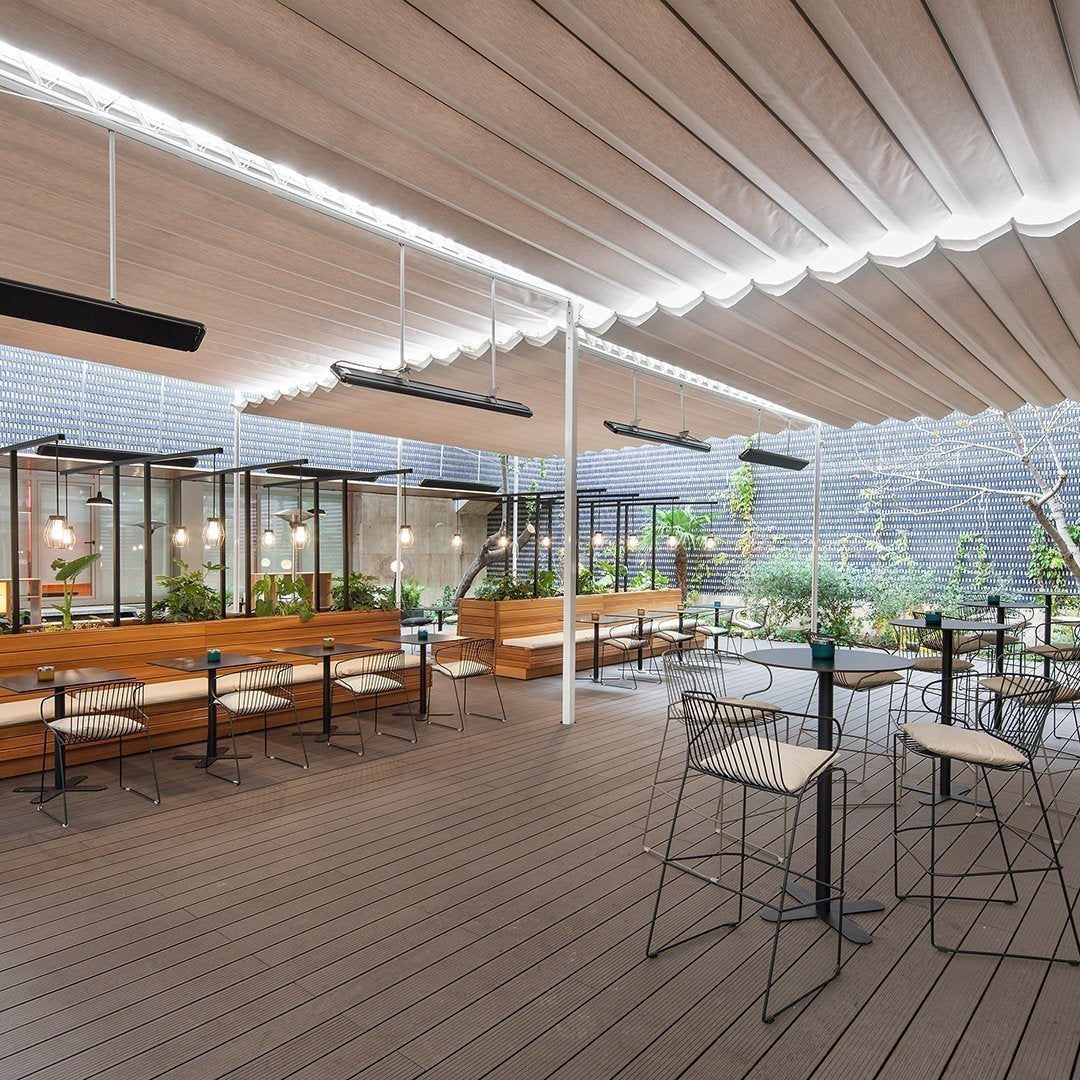 Modern outdoor dining area with neutral tones, wooden accents, and greenery, featuring a minimalist design and soft lighting.