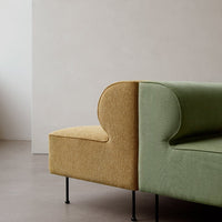 Two-tone sofa featuring a textured mustard yellow section and smooth olive green fabric, complemented by black legs.