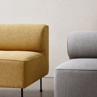 "Two modern sofas in rich mustard yellow and soft gray fabrics, showcasing minimalistic patterns and sleek lines."