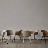 Collection of upholstered chairs in shades of gray, beige, and brown with various patterns and leg styles on a neutral backdrop.