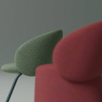 "Green patterned chair and red solid chair against a neutral backdrop, showcasing modern design elements."