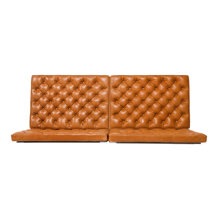 Brown tufted leather sofa with a diamond pattern, featuring a sleek minimalist design and plush cushioning.