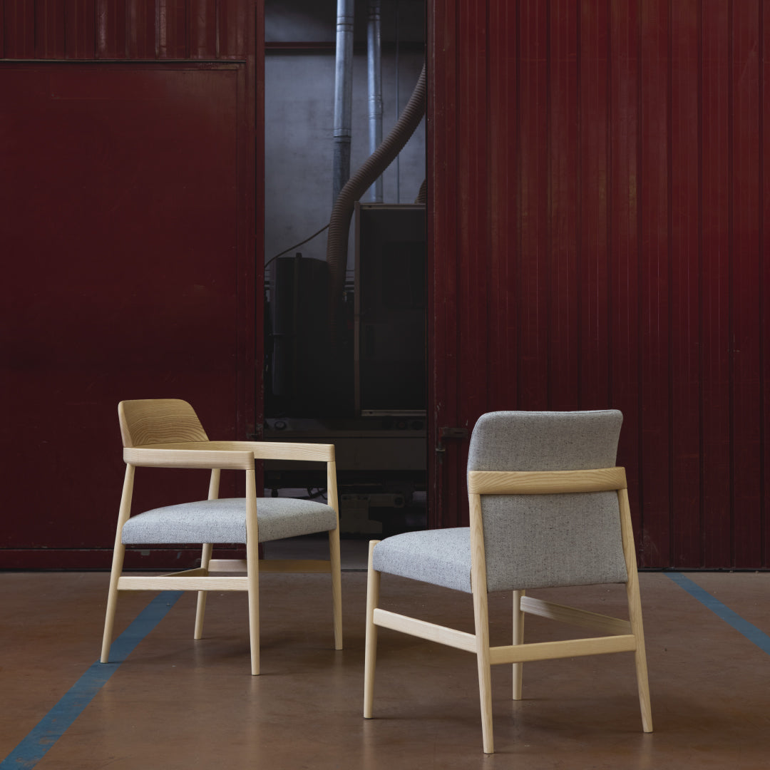 Light wood chairs with soft gray and beige upholstery, featuring a minimalist design and clean lines.