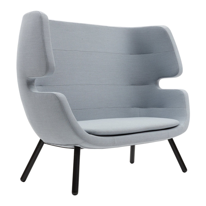 Light grey upholstered armchair with structured lines and smooth curves, featuring sleek black legs.