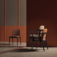Stylish chairs featuring a mix of earthy browns and muted tones against a warm, textured backdrop.