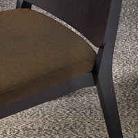 Brown fabric upholstery paired with a sleek black wood frame, showcasing a subtle texture and minimalist design.