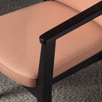 Blush pink upholstery with a sleek black frame, showcasing a modern, minimalist design.