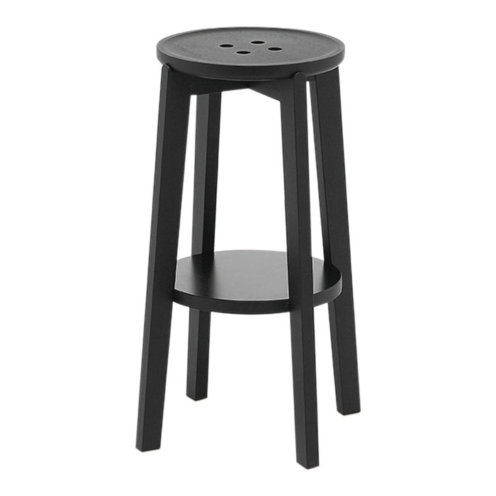 Black wooden stool with a round seat and simple design, featuring a lower shelf and three round holes on top.