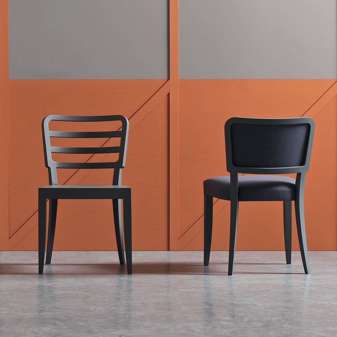 "Two modern chairs: one with black slatted backrest, the other with a sleek black cushion, set against orange geometric backdrop."
