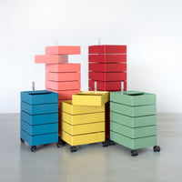Colorful stackable storage boxes in blue, green, yellow, coral, and red with sleek modern design.