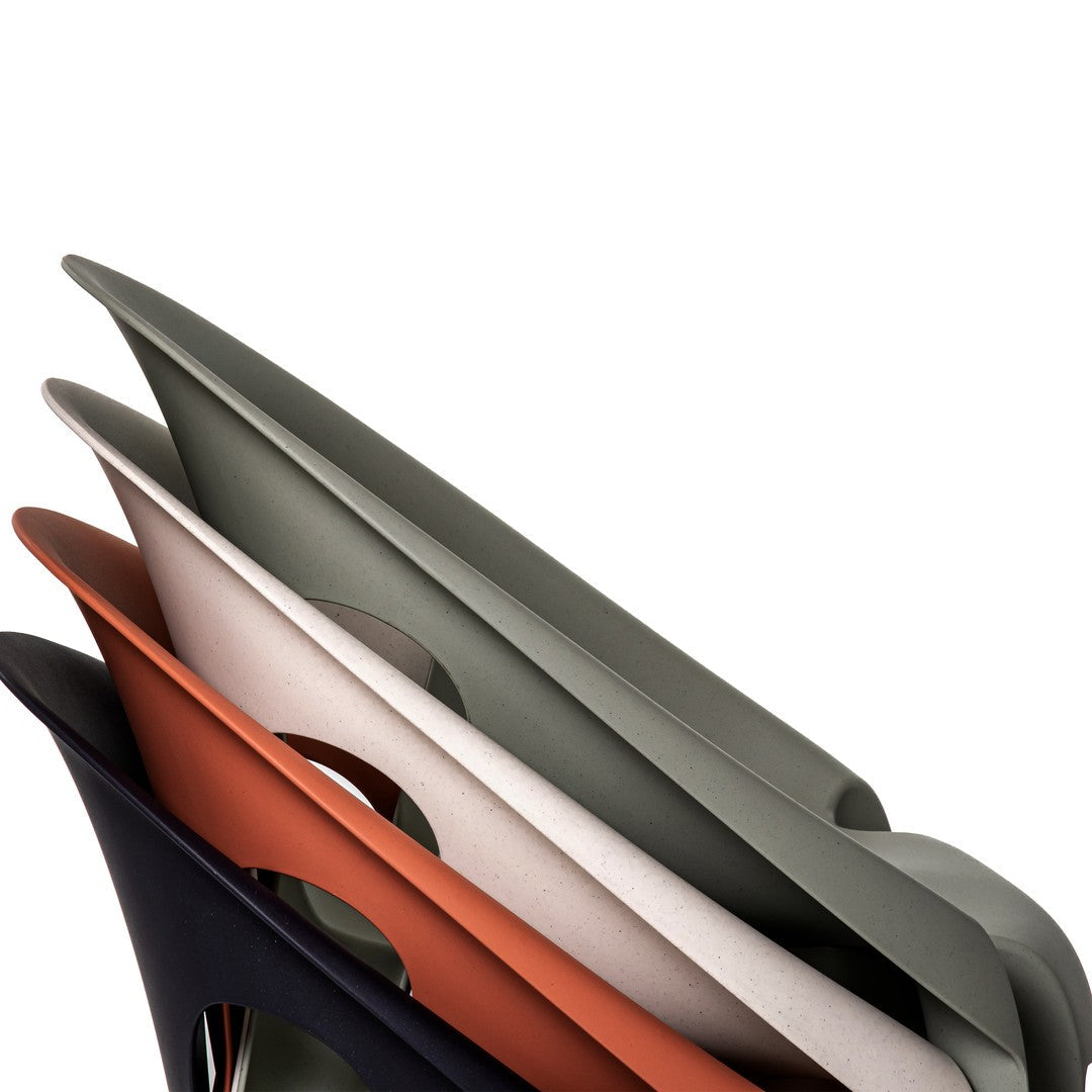 Colorful stacked trays in rust, green, cream, and black with smooth, modern designs. Perfect for stylish organization.