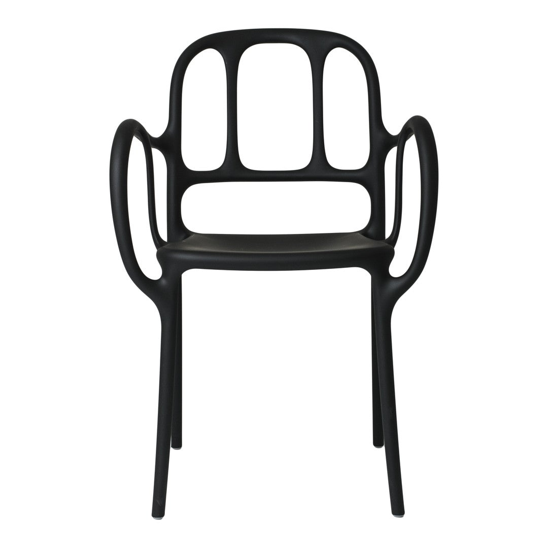 Black chair with a modern design, featuring smooth curves and an open backrest pattern. Ideal for contemporary decor.
