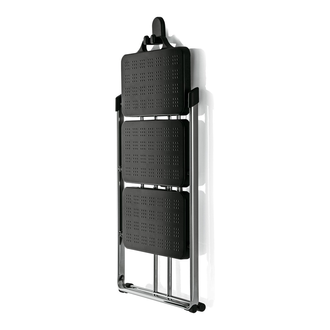 Black folding chair with patterned seats and shiny chrome frame, perfect for modern decor. Ideal for space-saving needs.