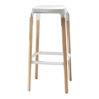 White bar stool with natural wood legs and a sleek design, featuring a minimalistic and modern aesthetic.